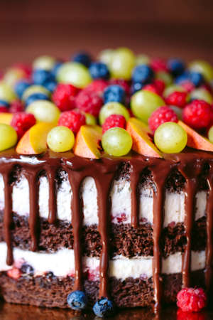 Fruit, cake naked. homemade cake with raspberries, grapes, and peach slices.の写真素材