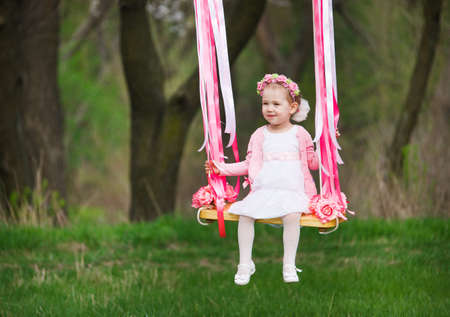 little cute girl on the swing, little girl at parkの写真素材