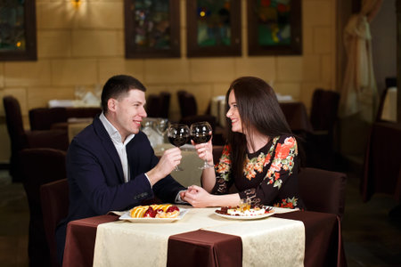 Marriage proposal at a restaurant. Couple toasting wineglasses in a luxury restaurant.