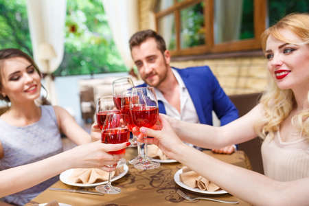 Friends drinking wine on the summer terrace.の写真素材