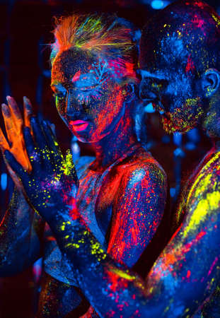 Portrait of a pair of lovers painted in fluorescent powder.の写真素材