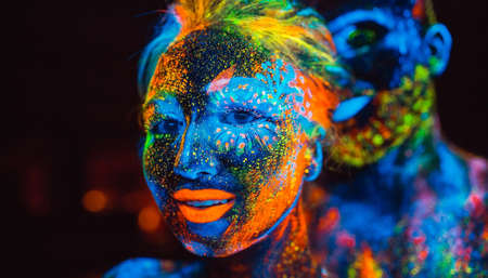 Portrait of a pair of lovers painted in fluorescent powder.の写真素材