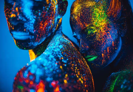 People are colored fluorescent powder. a pair of lovers dancing at a disco.の写真素材