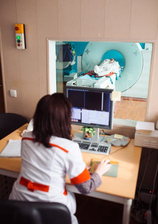 MRI machine and screens with doctor and nurse