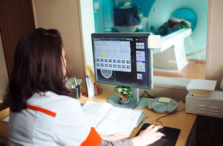 MRI machine and screens with doctor and nurseの写真素材