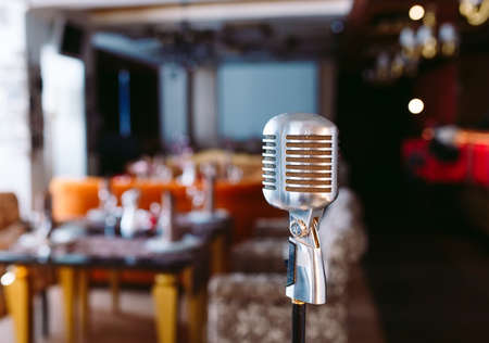 Retro karaoke microphone on restaurant background.の写真素材
