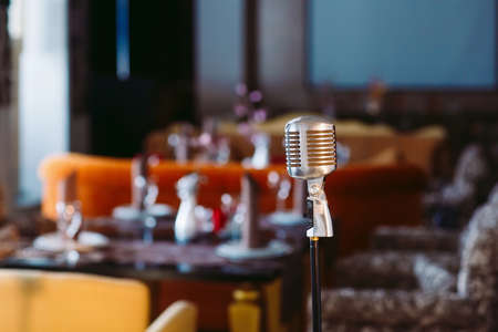 Retro karaoke microphone on restaurant background.の写真素材