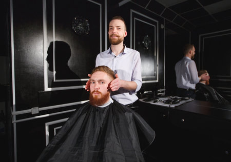 Confident man visiting hairstylist in barber shop.
