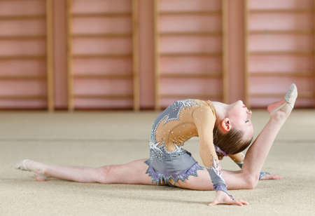 Young girl doing gymnastics in the gym.の写真素材