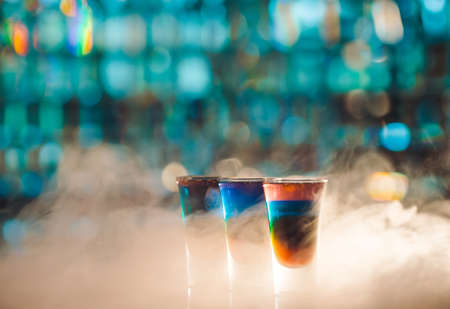 Multicolored shots on the bar in a smokeの写真素材