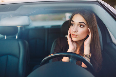 The girl in the car is in a traffic jam.