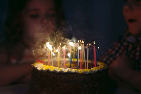 Birthday. A Kids blows out candles on the stokeの写真素材