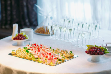Assortment of canapes with fresh vegetables and salad. Banquet service.