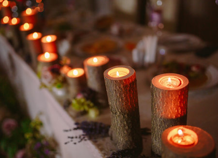 Wedding table setting with burning candles on the table.