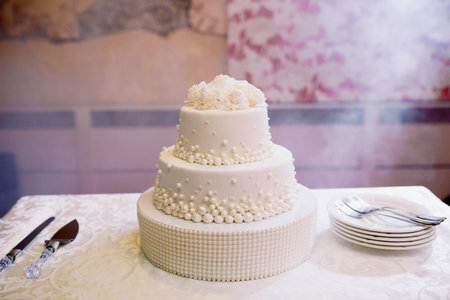 Wedding cake with white chocolate on the table.