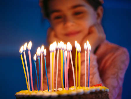 Portrait of little pretty girl with birthday cake.の写真素材