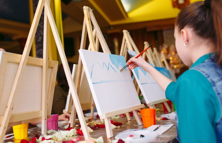 children painting picture at the art school.