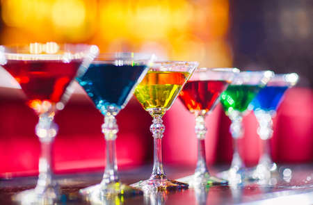 Multicolored cocktails at the bar counter. Barman show.の写真素材