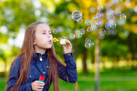 The girls run and play with soap bubbles.の写真素材