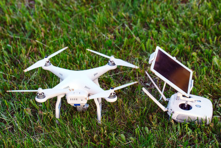 drone quad copter with high resolution digital camera and its remote control pad with smartphone on...