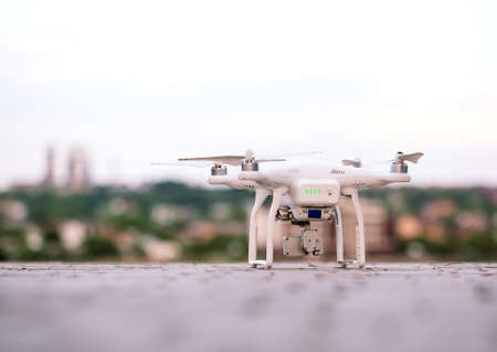 Drone with camera preparing to fly over the lakeの写真素材