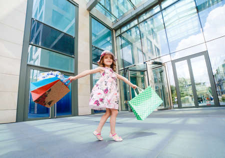 Cute little girl on shopping. Portrait of a kid with shopping bags. Shopping. girl.の写真素材