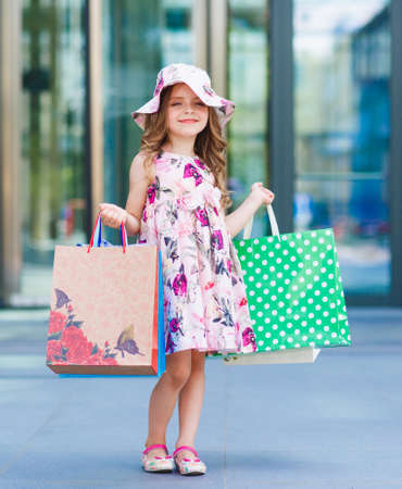 Cute little girl on shopping. Portrait of a kid with shopping bags. Shopping. girl.の写真素材