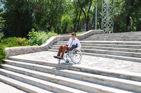 A young man in a wheelchair who can not descend the stairs.
