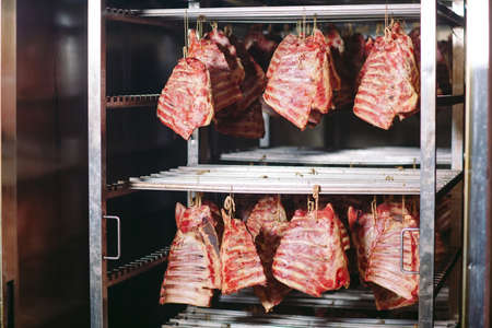 smoking meat in the smokehouse in a meat factoryの写真素材