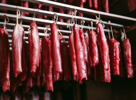 Smoked ham in the oven. Sausage production in the factory.の写真素材