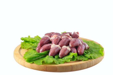 raw chicken hearts on white background on a wooden boardの写真素材