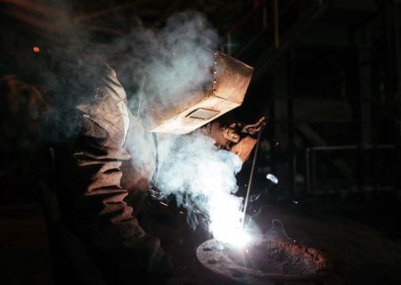 Industrial Worker at the factory welding closeup.