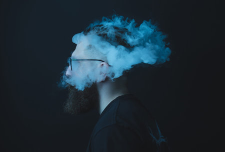 Concept. Smoke enveloped the head man. Portrait of a Bearded, stylish man with smoke. Secondhand...