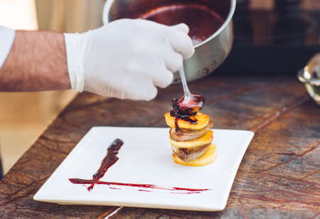 Foie Gras with sauce in a white plate.の写真素材