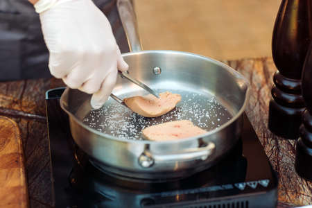 Goose liver on a wooden Board in the restaurant before cookingの写真素材