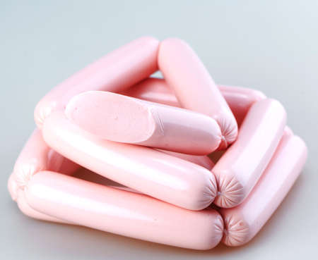 fresh tasty sausage isolated on a white backgroundの写真素材