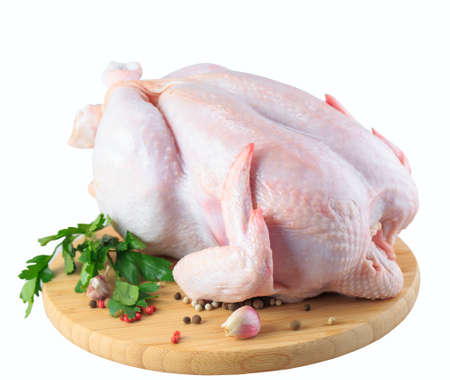 raw chicken carcass on the cutting board isolated on white background.の写真素材