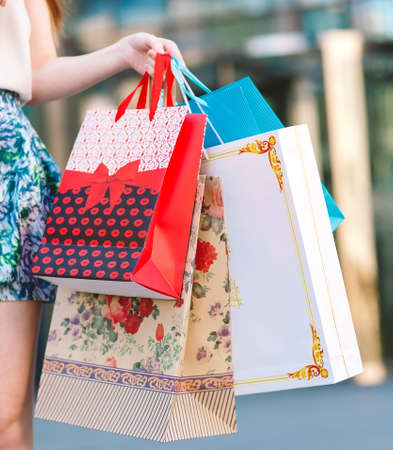 A girl with shopping bags in hands.の写真素材