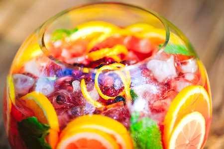 Summer cocktail. Fruit cocktail on green background. Citrus fruits, berries, strawberries, blueberries mint iceの写真素材