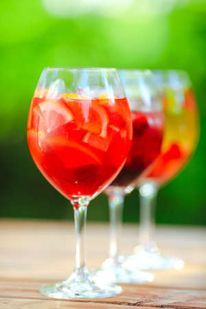 Summer cocktail. Fruit cocktail on green background. Citrus fruits, berries, strawberries, blueberries, mint, iceの写真素材