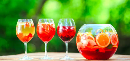 Summer cocktail. Fruit cocktail on green background. Citrus fruits, berries, strawberries, blueberries, mint, iceの写真素材