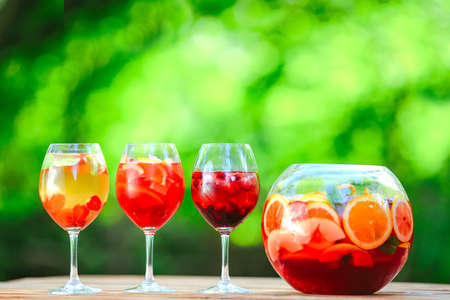 Summer cocktail. Fruit cocktail on green background. Citrus fruits, berries, strawberries, blueberries, mint, iceの写真素材