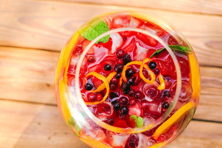 Summer cocktail. Fruit cocktail on green background. Citrus fruits, berries, strawberries,...