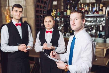 Managers briefing with the waiters. Restaurant manager and his staffの写真素材