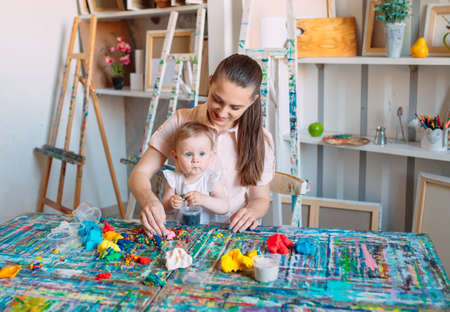 Mother and daughter playing with the kinetic sand.の写真素材