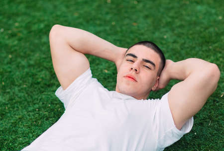 Sporty man training in on the grassの写真素材