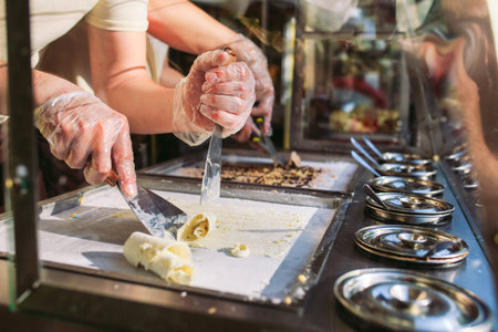 stir-fried ice cream rolls at freeze pan. Organic, natural rolled ice cream, hand made dessert.