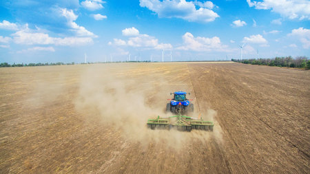 A tractor plowing and sowing in the field