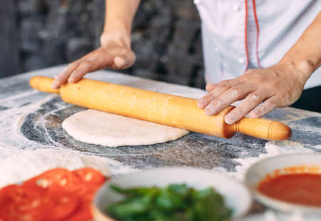 Cooking Pizza. Pizza ingredients on the table.の写真素材