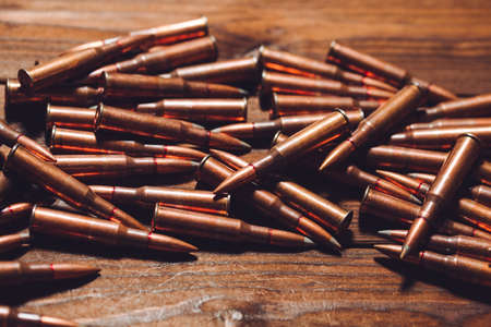 Bullets on a wooden background. Military concept.の写真素材